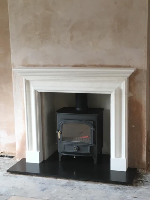 Clearview Vision 500 log burner in marble fireplace, installed in Sevenoaks