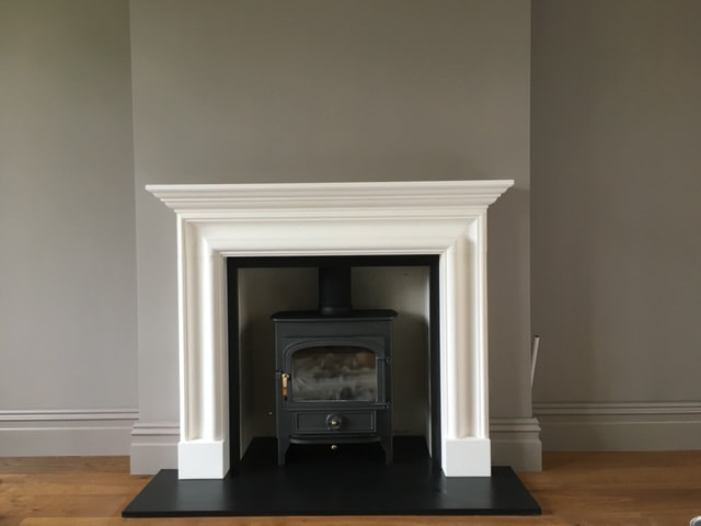 Clearview Vision 500 stove in limestone fire surround