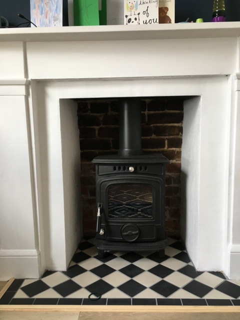 Wood burning stove with tiled hearth