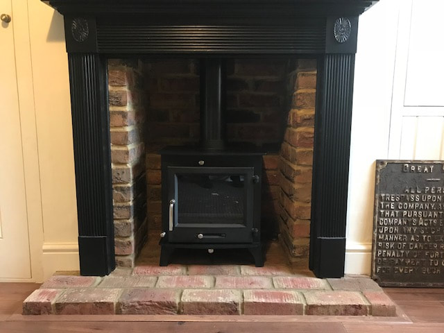 Fireplace repainted and wood burning stove installed