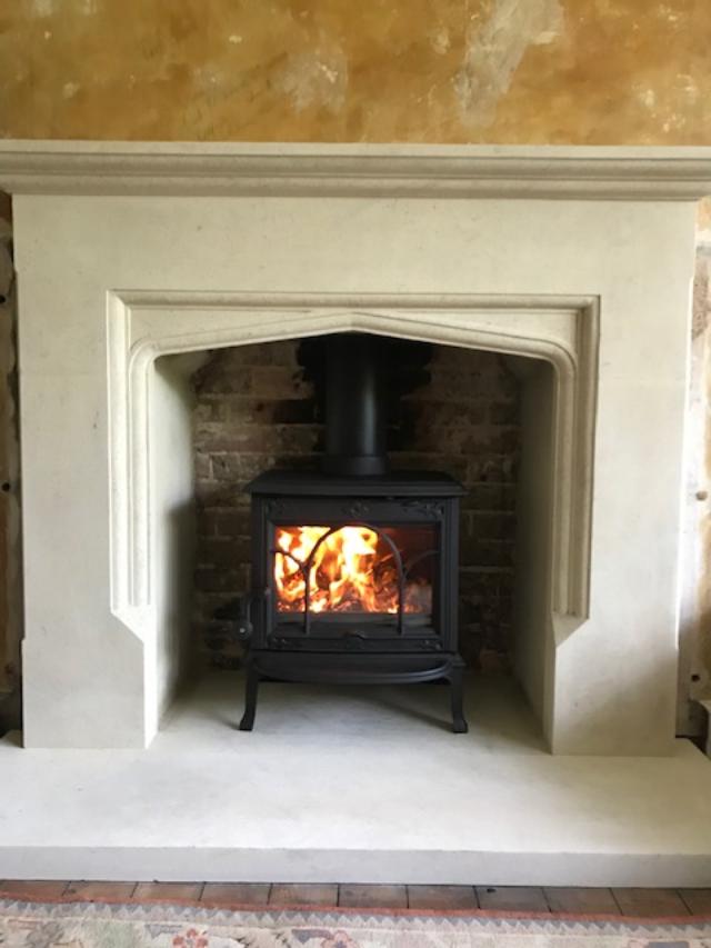 Jotul F100 stove in stone fire surround, fitted Sevenoaks house