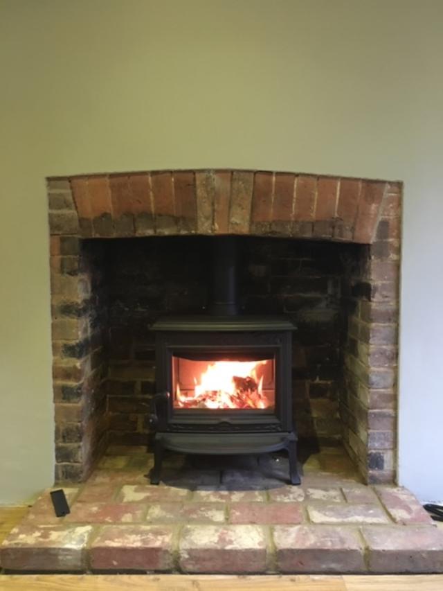Traditional Jotul multi-fuel stove in brick lined fire opening, fitted in Tunbridge Wells.
